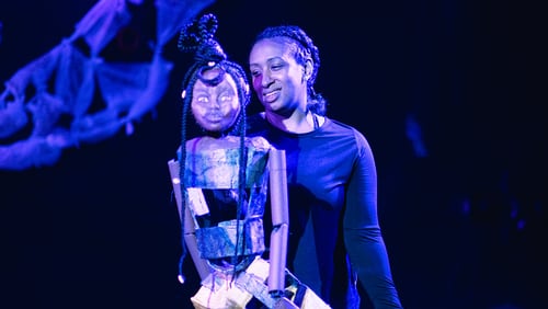 Actress Kahalilah Smith manipulates the human puppet in a production of "Human," continuing through Jan. 28 at the Center for Puppetry Arts.