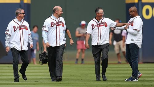 October 02, 2016 Atlanta: Greg Maddux gives Andruw Jones a friendly fist pump to the chest as he takes the field with Tom Glavine and John Smoltz for the Braves final game at Turner Field on Sunday, Oct. 2, 2016, in Atlanta. Curtis Compton /ccompton@ajc.com