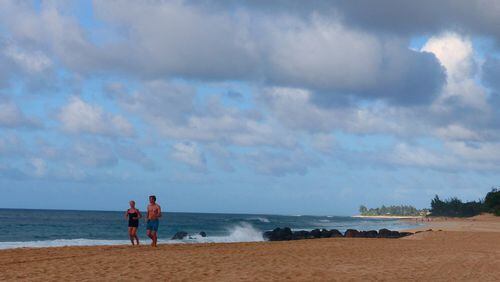 Morning joggers on the beach on Oahu's North Shore. (Brian J. Cantwell/Seattle Times/TNS)