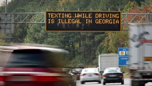 October 25, 2012 - Atlanta, Ga: A highway warning sign on I-285 westbound alert motorists that, "Texting while driving is illegal in Georgia, " before exit 22 near I-75 on the north side of Atlanta Thursday afternoon in Atlanta, Ga., October 25, 2012. Georgia's law outlawing texting while driving has proven diffficult to enforce. Police are writing fewer tickets than expected, raking in far less revenue than supporters of the measure had hoped. JASON GETZ / JGETZ@AJC.COM
