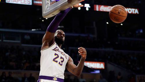 Lakers' LeBron James (23) dunks against the Atlanta Hawks on Sunday night in Los Angeles. (AP Photo/Marcio Jose Sanchez)