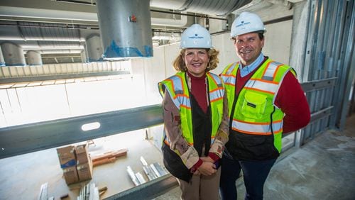 Aurora Theatre's new $31 million theater complex in downtown Lawrenceville is under construction Monday, March 8, 2021.  The theatre's co-founders Ann-Carol Pence, left, and Anthony Rodriguez, right, tour the area above the smaller second theater, the cabaret space, which has folding glass walls opening the space to the outdoor courtyard and available as a rented venue.    The project is a partnership with Lawrenceville, the development adds two new public performance spaces, creates outdoor green space for the community and provides technical and backstage options significantly increasing the theater's capabilities.  (Jenni Girtman for The Atlanta Journal-Constitution)