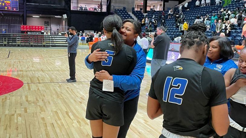 Mount Paran's Kara Dunn (5) celebrates with her mother and coach, Stephanie Dunn, after the Eagles' 54-49 victory over Hebron Christian is the Class A Private girls basketball championship game on March 12, 2022, at the Macon Coliseum.