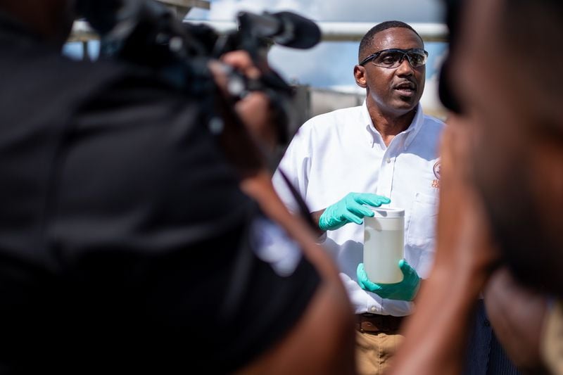 Fulton County Lab Manager Patrick Person holds a sample of sewage at the Camp Creek Water Reclamation Facility on Tuesday morning, July 26, 2022. The sample is used to test for Covid-19 and monkey pox infections in the community.  Ben Gray for the Atlanta Journal-Constitution