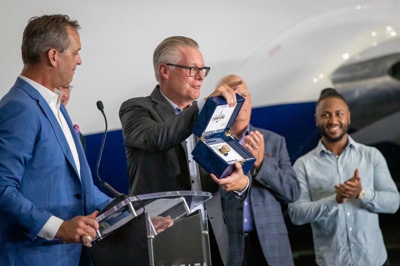 Chief Executive Officer of Delta Air Lines Ed Bastian holds a 2021 World Series ring that was presented to him during a ceremony that revealed the Delta Air Lines jet dedicated to the Braves championship Thursday, July 28, 2022. (Steve Schaefer / steve.schaefer@ajc.com)