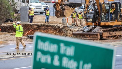 Crews worked to repair a water main break that caused a large section of Indian Trail Road to collapse in Norcross early Tuesday morning.