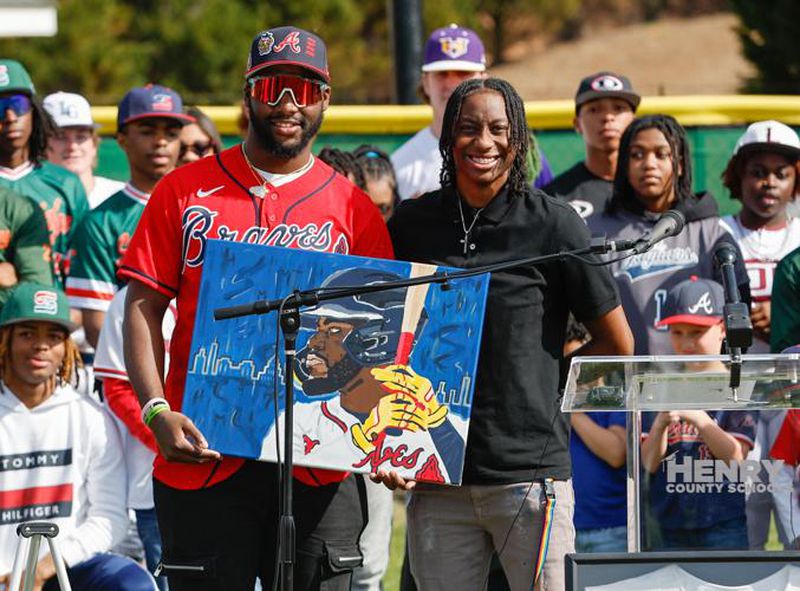 Stockbridge High student Carrington Wilson, right, presented Braves outfielder Michael Harris II with a painting during Michael Harris II Day on February 7, 2023. (Photo Courtesy of Ben Ennis)