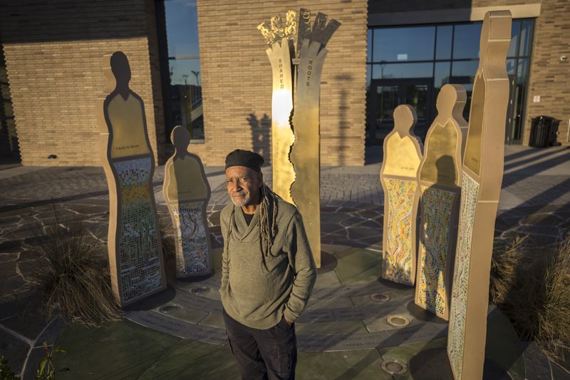 SAVANNAH, GA - FEBRUARY 07, 2024: World-renowned sculpture Jerome Meadows stands near his public piece titled, "Of Communities and the Land and the Trees that Bear Witness to Them", outside of the Enmarket Arena, Wednesday, Feb. 7, 2024, in Savannah, Ga. (AJC Photo/Stephen B. Morton)