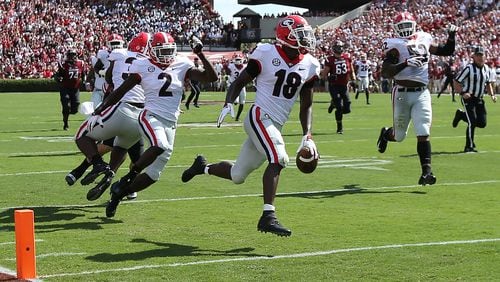 Georgia defensive back Deandre Baker would have had a touchdown on this interception return, if only he hadn't dropped the ball a half-step early. No matter, the Bulldogs comfortably beat South Carolina. (Curtis Compton/ccompton@ajc.com)