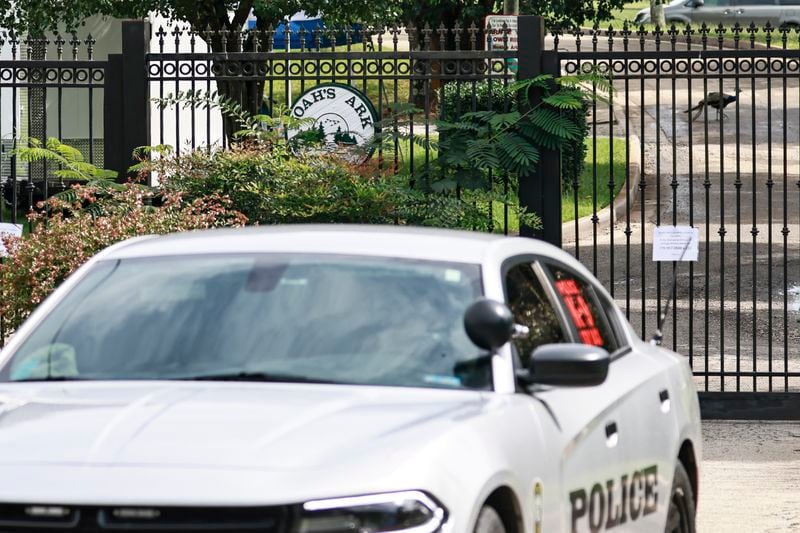 A Henry County police car sits at the entrance of Noah’s Ark Animal Sanctuary in Locust Grove on Monday, August 22, 2022. (Natrice Miller/natrice.miller@ajc.com)