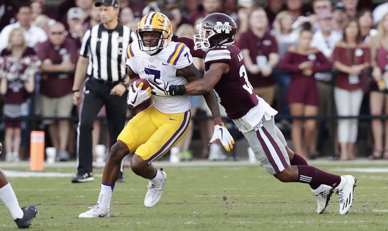 Mississippi State defensive back Johnathan Abram tackles LSU wide receiver D.J. Chark during the first half  of their SEC mathcup Saturday, Sept. 16, 2017, in Starkville, Miss. Mississippi State won, 37-7.