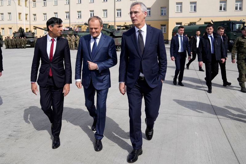 Britain's Prime Minister Rishi Sunak, left, Poland's Prime Minister Donald Tusk and NATO Secretary General Jens Stoltenberg arrive together at the Armourd Brigade barracks in Warsaw, Poland, Tuesday, April 23, 2024.(AP Photo/Alastair Grant, Pool)