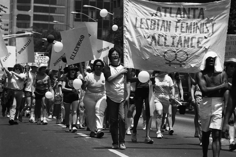 Members of the Atlanta Lesbian Feminist Alliance and others march down Peachtree Street in the 1986 Gay Pride Parade. AJC / 1986