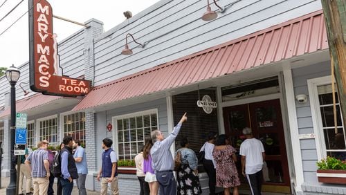 A line forms Wednesday for the reopening of Mary Mac’s Tea Room in Midtown Atlanta. The iconic restaurant’s roof collapsed after a storm in March.