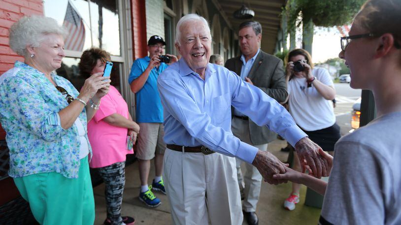 (file photo) President Jimmy Carter shakes hands as he arrives at a birthday party for his wife Rosalynn on Saturday August 22, 2015 in Plains, Georgia. Ben Gray / bgray@ajc.com
