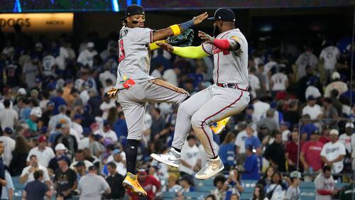 Atlanta Braves' Ronald Acuna Jr., left, celebrates with Marcell Ozuna after the Braves defeated the Los Angeles Dodgers 8-7 in a baseball game Thursday, Aug. 31, 2023, in Los Angeles. (AP Photo/Mark J. Terrill)