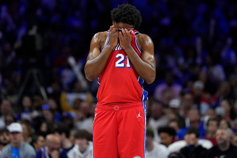 Philadelphia 76ers' Joel Embiid wipes his face during the second half of Game 4 in an NBA basketball first-round playoff series against the New York Knicks, Sunday, April 28, 2024, in Philadelphia. (AP Photo/Matt Slocum)