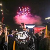 A fireworks display is shown as University of Georgia students react during the closing ceremony of the Spring Undergraduate Commencement at Sanford Stadium, Friday, May 12, 2023, in Athens, Ga. (Jason Getz / Jason.Getz@ajc.com)