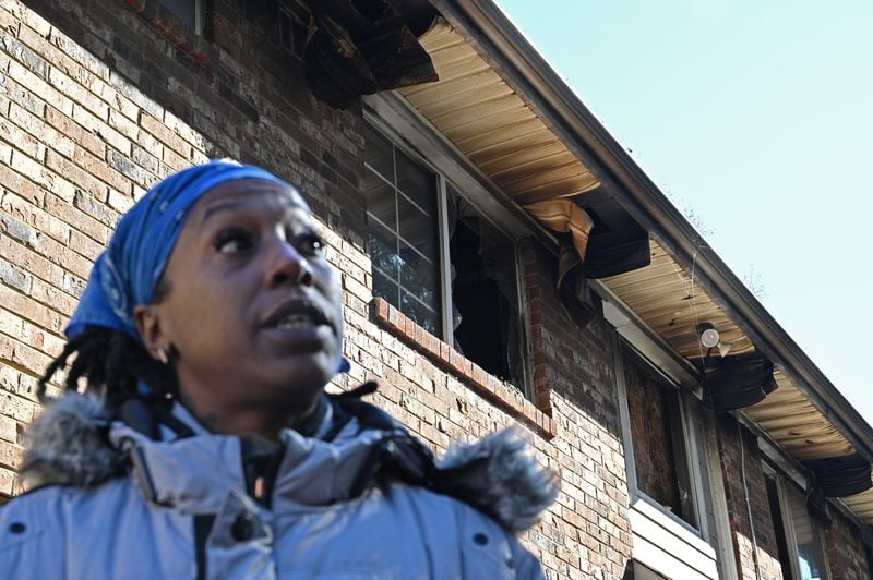 Danielle Russell, a Pavilion Place resident, shows how apartments in her building remained open to the elements and squatters weeks after a Sept. 23 fire. After the fire, electricity flickered on and off in her apartment, and rats became more numerous. Landlords declined to move her and other residents to different units in the complex. (Hyosub Shin / hyosub.shin@ajc.com)