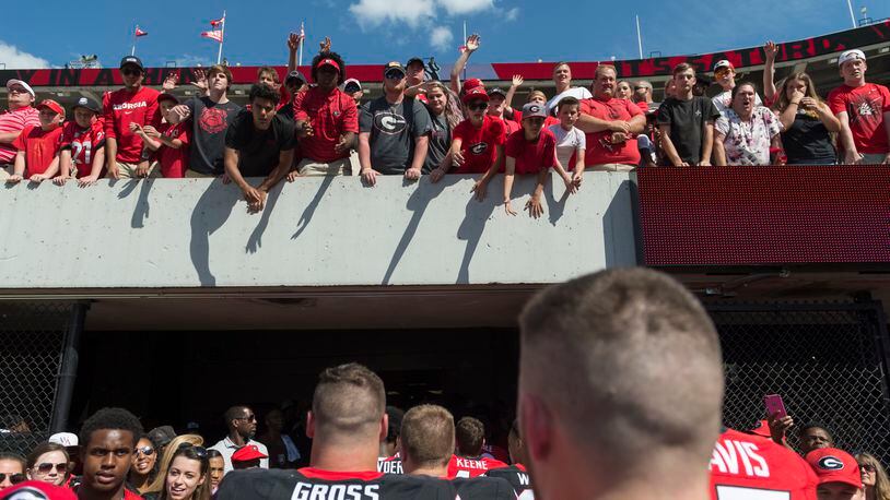 Fans cheer as Georgia players leave the field after the G-Day game in Athens, Georgia, on Saturday, April 22, 2017. The Red team defeated the Black team 25-22. (DAVID BARNES / AJC file)