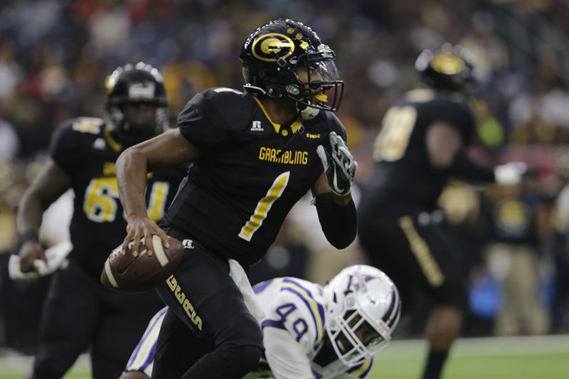 Grambling State quarterback Devante Kincade (1) rolls out and looks to pass in the first quarter against Alcorn during the Southwestern Athletic Conference championship football game in Houston, Texas, Saturday, Dec. 2, 2017.