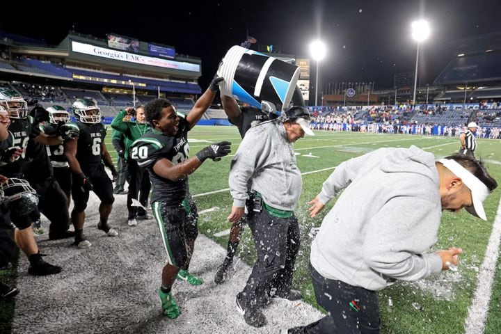 Collins Hill head coach Lenny Gregory gets dumped with Gatorade in the closing minute of their 24-8 win against Milton in the Class 7A state title football game at Georgia State Center Parc Stadium Saturday, December 11, 2021, Atlanta. JASON GETZ FOR THE ATLANTA JOURNAL-CONSTITUTION