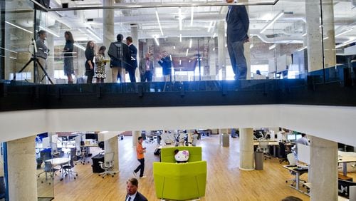 James Irwin (top right) and Michael Phillips (bottom left) check out the 75,000 square foot offices of athenahealth at Ponce City Market in Atlanta on Sept. 30. The healthcare agency moved its offices from the suburbs to the city.
