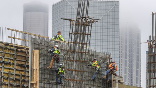 Overall, metro Atlanta added 72,000 jobs last year. The construction sector, which has about 146,000 workers, grew by 4,700. Here, workers on an 18-story, 304-unit apartment tower being built across from Mercedes-Benz Stadium near downtown. (John Spink / John.Spink@ajc.com)