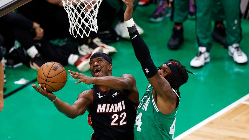 Miami Heat forward Jimmy Butler, left, shoots as Boston Celtics center Robert Williams III defends during the second half in Game 7 of the NBA basketball Eastern Conference finals Monday, May 29, 2023, in Boston. (AP Photo/Michael Dwyer)