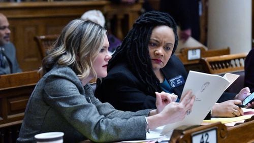 State Sen. Elena Parent (left) and Sen. Nikema Williams confer during the morning session of the ninth day of the 2020 General Assembly at the Georgia State Capitol in Atlanta on Friday, January 31, 2020. (Hyosub Shin / Hyosub.Shin@ajc.com)