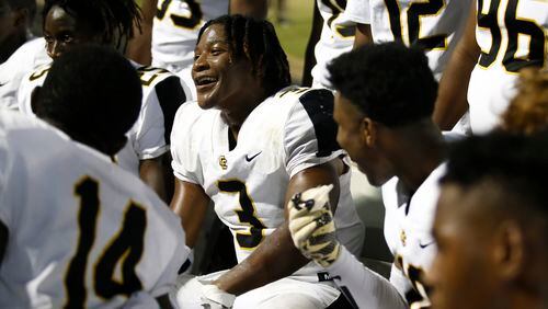 Colquitt County's Camari "Juicy" Louis (3) celebrates with teammates after nearly running his interception to the end zone during the first half of a high school football game between Grayson and Colquitt County at Grayson High School in Loganville, Ga., on Fri., Sept. 21, 2018. (Casey Sykes for The Atlanta Journal-Constitution)