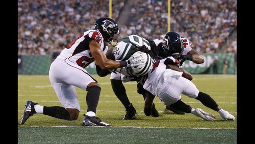New York Jets running back Isaiah Crowell (20) breaks a tackle by Atlanta Falcons' Isaiah Oliver (20) to score a touchdown during the first half of a preseason NFL football game Friday, Aug. 10, 2018, in East Rutherford, N.J.  Riley is behind the play. (AP Photo/Adam Hunger)