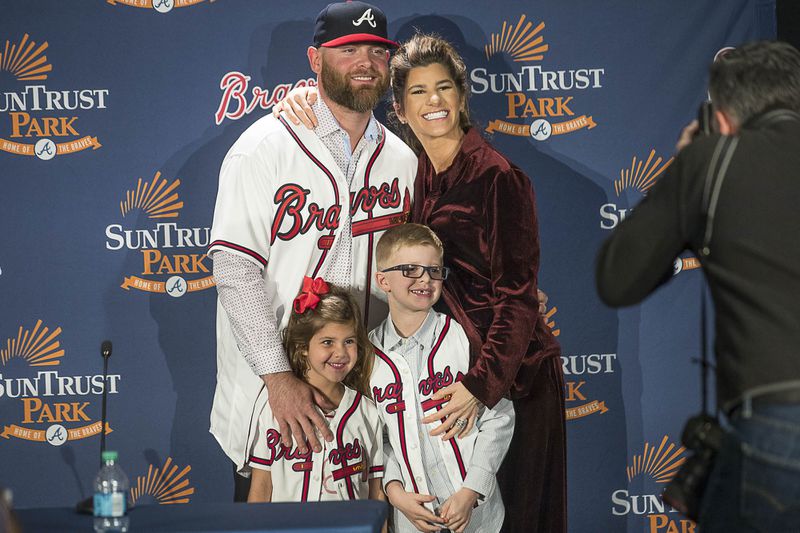 Brian McCann and wife Ashley pose for a photo with children Colt (right) and Colbie (left) following Monday's press conference. (Alyssa Pointer/Alyssa.Pointer@ajc.com)