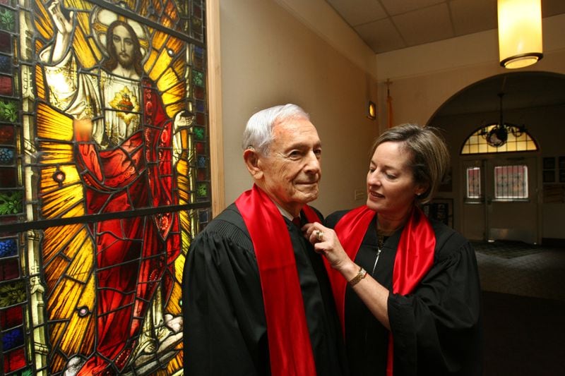 In 2009, Judge Marvin Shoob and his daugher, then-Fulton County Superior Court Judge Wendy Shoob, prepare before leading a procession of 50 judges in front of Scared Heart Catholic Church, celebrating the traditional “Red Mass” to seek blessings for the judicial system and pray for peace and justice. (KEITH HADLEY/AJC staff)