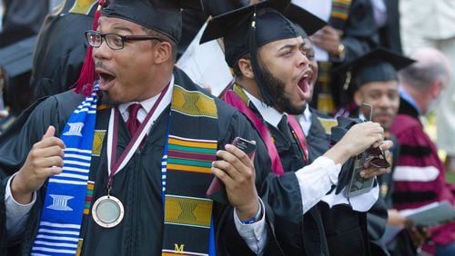 Graduates react after hearing billionaire Robert F. Smith is paying all student debt for the Class of 2019 during the Morehouse College graduation ceremony in Atlanta on Sunday, May 19, 2019. STEVE SCHAEFER / SPECIAL TO THE AJC