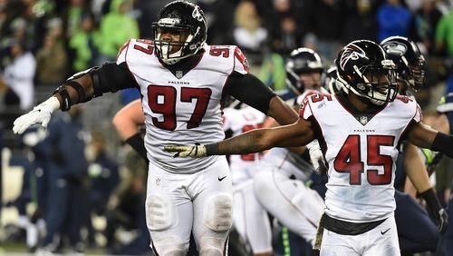 Falcons defensive tackle Grady Jarrett #97 and middle linebacker Deion Jones #45 react after the Seahawks missed a long field goal attempt in the last minute of the during the fourth quarter of the game at CenturyLink Field on Monday night in Seattle, Washington. The Falcons won the game 34-31.