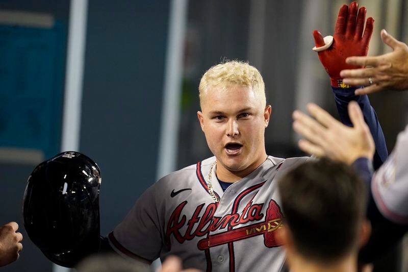 Braves' Joc Pederson celebrates in the dugout after hitting a solo home run against the Los Angeles Dodgers during the third inning  Aug. 31, 2021, in Los Angeles. (AP Photo/Marcio Jose Sanchez)