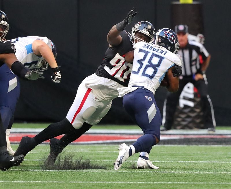 Falcons defensive lineman Marlon Davidson tackles Tennessee Titans running back Mekhi Sargent during the first half of exhibition game Friday, Aug. 13, 2021, at Mercedes-Benz Stadium in Atlanta. (Curtis Compton / Curtis.Compton@ajc.com)