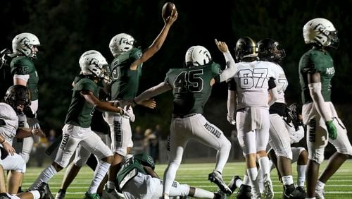 Kennesaw Mountain defensive players signal a turnover after Sprayberry fumbled the ball in the second half of play at Kennesaw Mountain High School Friday, Sept. 10, 2021. (Daniel Varnado/For the AJC)