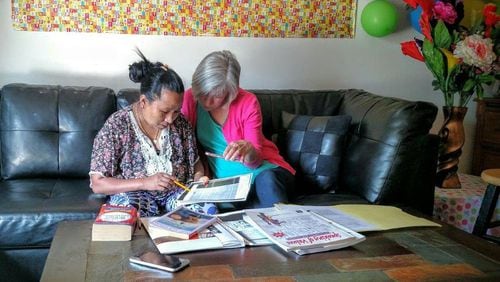 New American Pathways volunteer Carol Hamilton helps Bhim Tamangwith her homework. HANDOUT