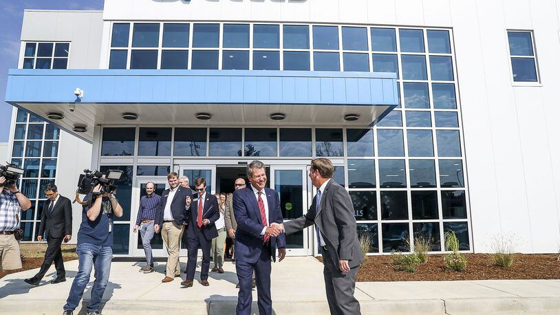 Dalton, Georgia — Gov. Brian Kemp is greeted after finishing a tour of the Hanwha Q Cells solar manufacturing facility in Dalton. The plant started production earlier this year. It is billed as the largest solar panel assembly plant in the Western Hemisphere. (Alyssa Pointer/alyssa.pointer@ajc.com)
