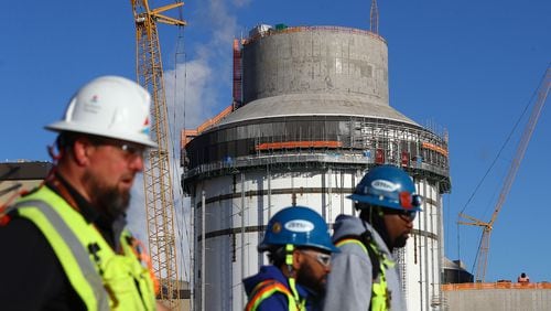 Some of the thousands of construction workers pass by the exterior of unit 4 at Georgia Power's Plant Vogtle nuclear project on Tuesday, Dec 14, 2021, in Waynesboro, Georgia.   “Curtis Compton / Curtis.Compton@ajc.com”`
