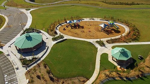 A new section of Alexander Park, 955 Scenic Highway/ Ga 124 in Lawrenceville, will open soon, featuring new playground equipment, a dog park, trails, additional parking, and restrooms. (Courtesy Gwinnett County)