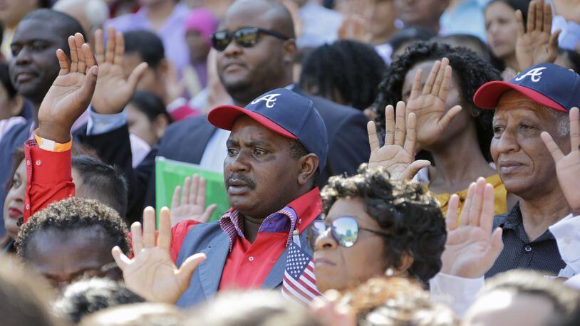 New citizens take their oath of allegiance at Turner Field. BOB ANDRES /BANDRES@AJC.COM