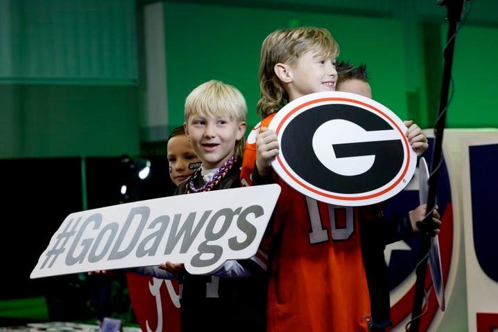Mason Freeman, 7, and his brother, Jack, 9, have fun in the 3d photo booth at Fan Central in the Indiana Convention Center at the 2022 College Football Playoff National Championship  between the Georgia Bulldogs and the Alabama Crimson Tide at Lucas Oil Stadium in Indianapolis on Saturday, January 8, 2022.   Bob Andres / robert.andres@ajc.com