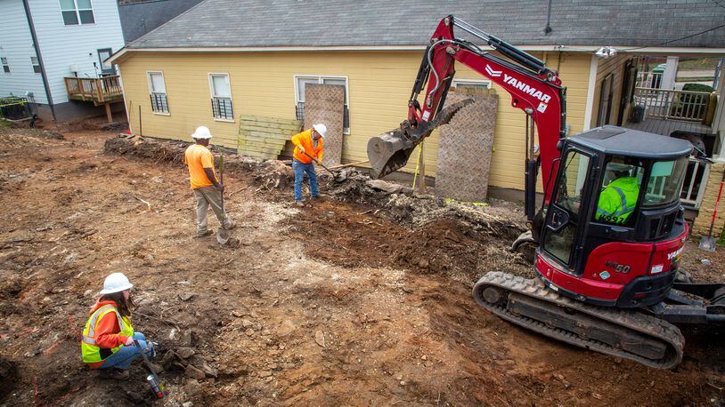 Workers remove dirt from a property that is part of the Westside Lead Superfund site in Atlanta Wednesday, February 2, 2022.   STEVE SCHAEFER FOR THE ATLANTA JOURNAL-CONSTITUTION