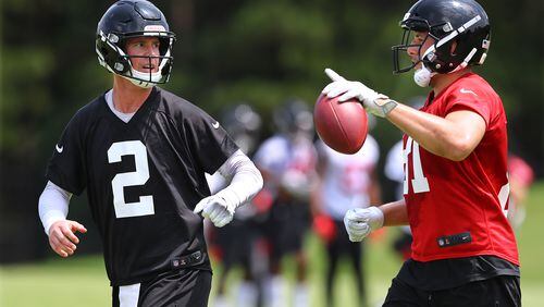 Atlanta Falcons quarterback Matt Ryan and tight end Austin Hooper confer after running a play during team practice Thursday, May 23, 2019, in Flowery Branch.