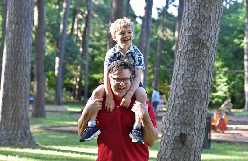 “Daddy K” (aka Keith Schumann) gives 4-year-old Owen a boost during a day in the park. HYOSUB SHIN / HSHIN@AJC.COM