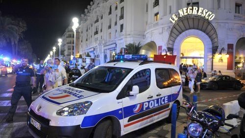 A police car is parked near the scene of an attack after a truck drove onto the sidewalk and plowed through a crowd of revelers who'd gathered to watch the fireworks. Five years ago in France, a man drove a truck through crowds celebrating Bastille Day along Nice’s beachfront, killing 86 and wounding more than 100. (AP Photo/Christian Alminana)