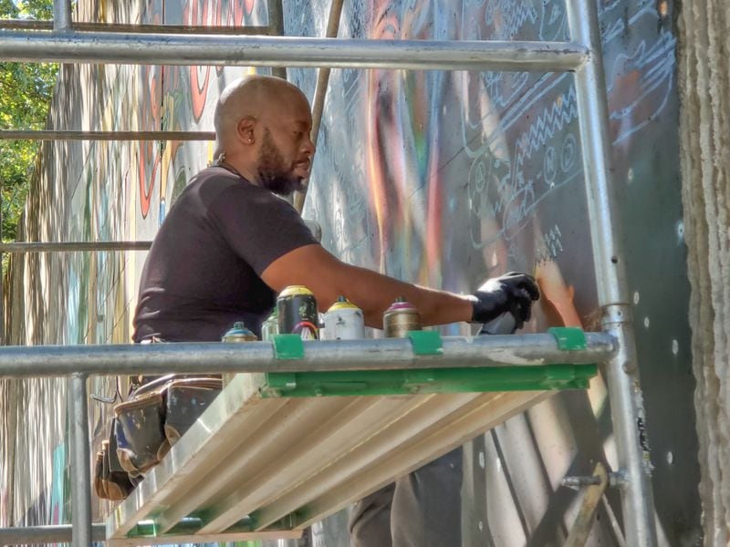 Fabian Williams at work on a mural in Cabbagetown.